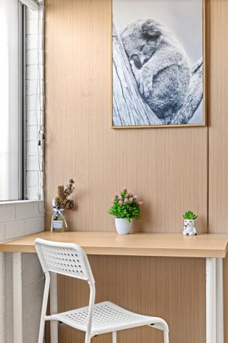 a desk with a white chair and a picture on the wall at Smart Stay with Convenience - Private Single Room in Liverpool - Shared Bathroom in Liverpool