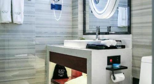 a bathroom with a sink and a mirror at Xana Hotelle Xi'an GONG IP South Gate of Zhonglou in Xi'an