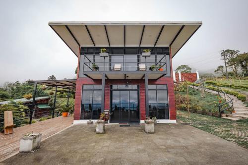 a house with a large glass door in front of it at Loft con hermosas vistas y Volcán Turrialba in Turrialba
