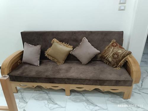 a couch with pillows on it in a room at شقق فندقية تشطيب سوبر لوكس in Mît Khamîs