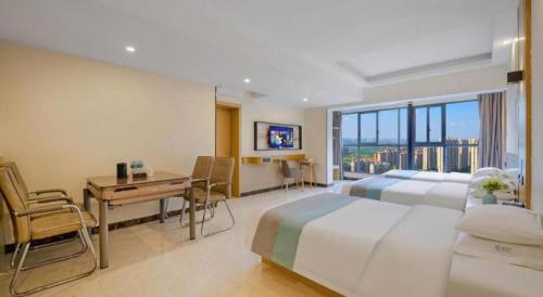 a hotel room with two beds and a desk and a deskablish at City Comfort Inn Kunming High Speed Railway South Station Yongxin Harvard in Kunming