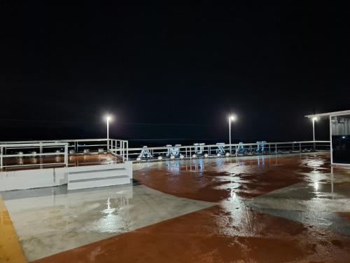 a parking lot at night with lights on at Hazuma Homestay in Tawangmangu