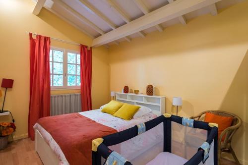 une chambre avec un lit et une fenêtre dans l'établissement VILLA ESCAPADES AU FERRET idéal Famille ou groupe d'Amis avec piscine chauffée 5 chambres Proche plages et pistes cyclables commerces Séjour paisible au cœur du Bassin d'Arcachon Nous répondons très rapidement aux demandes de renseignements, à Lège-Cap-Ferret