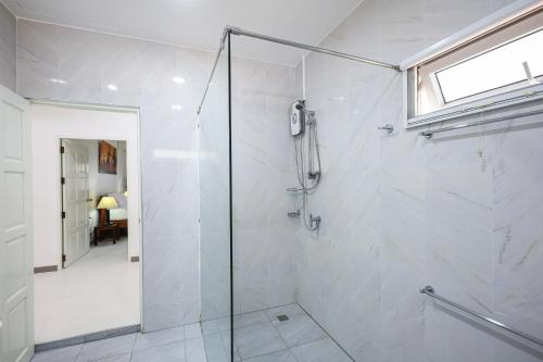 a bathroom with a shower with a glass door at V201 1BR Pool Access Walk to Yanui Beach in Nai Harn Beach
