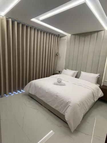 a bedroom with a large white bed with a bowl on it at Moraji tanger apartment in Tangier