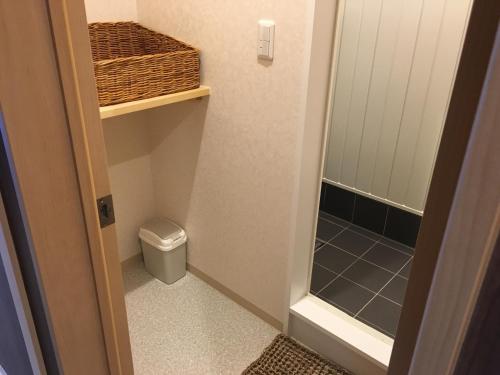 a small bathroom with a toilet and a walk in shower at GuestHouse Guu in Fujikawaguchiko