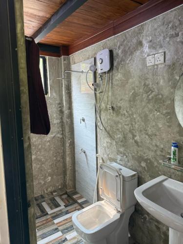 a bathroom with a toilet and a sink at RMC Cabana in Udamulla