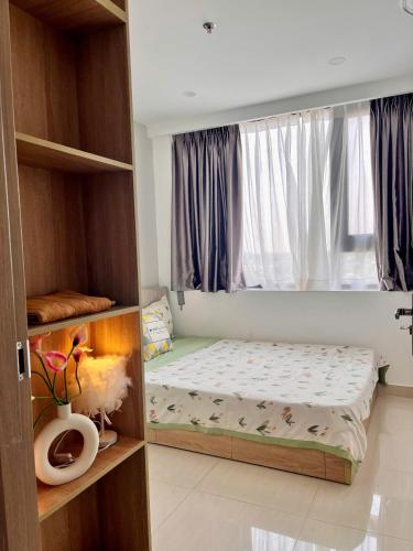 a small bedroom with a bed and a window at Châu Giang Homestay, Nera Garden Huế in Thôn Văn Dương