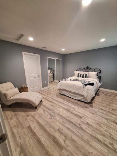 a bedroom with a bed and a wooden floor at My amazing home in Azusa