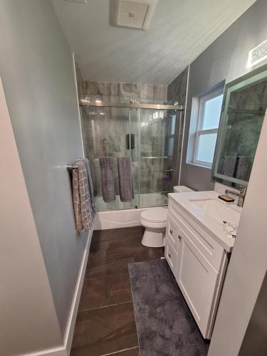 a bathroom with a shower and a toilet and a sink at My amazing home in Azusa