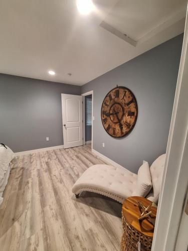 a living room with a couch and a clock on the wall at My amazing home in Azusa