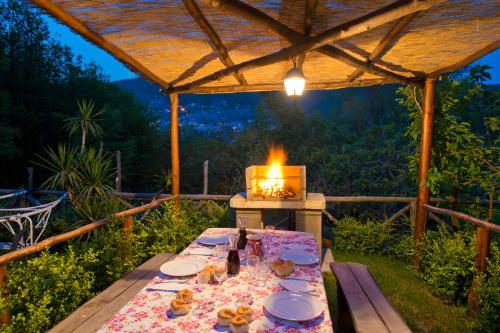 a table with plates of food sitting under a tent at Haidi House in Agerola