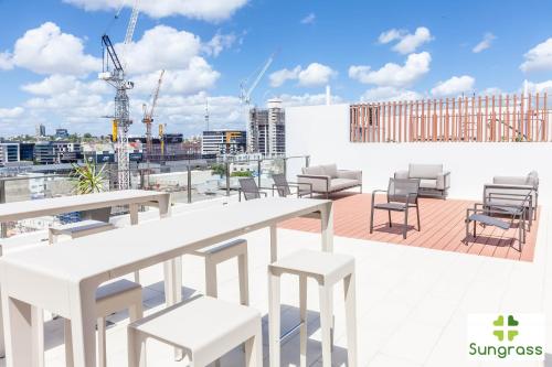 a balcony with tables and chairs on a building at Fleet Lane Apartments in Brisbane