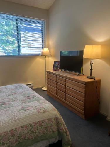 a bedroom with a bed and a flat screen tv at Eagle Summit Collection in Mammoth Lakes