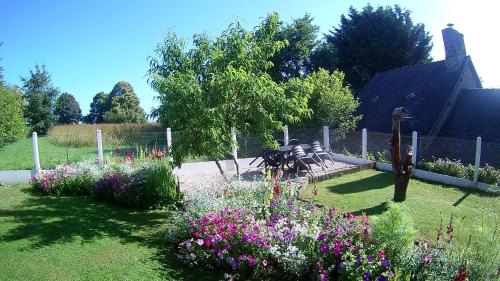a park with benches and flowers in a garden at gîte de LA LANFRAYERE in Saint-Mars-sur-Colmont