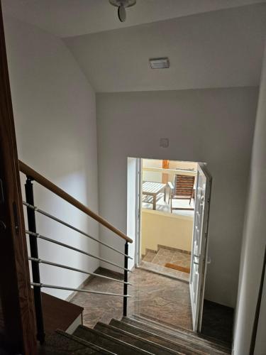 a staircase with a glass door leading into a room at Dežman Apartments & Rooms in Kranj