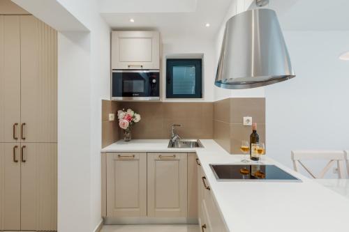 a kitchen with a sink and a microwave at Apartments Los Olivos in Kotor