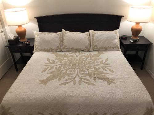 a bedroom with a large bed with two night stands at Kauai Getaway Condo in Kapaa