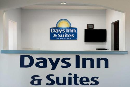 a sign that says days inn and suites and suites at Days Inn & Suites by Wyndham Byram in Byram