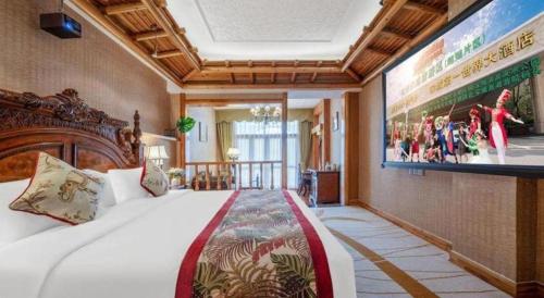 a hotel room with a large bed and a tv at Hangzhou The First World Hotel in Hangzhou