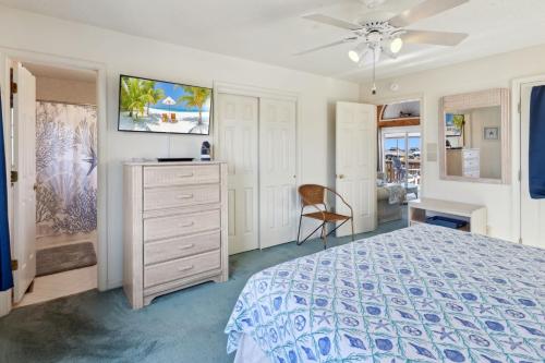 a bedroom with a bed and a dresser at 6133 - Coastal Crave in Nags Head
