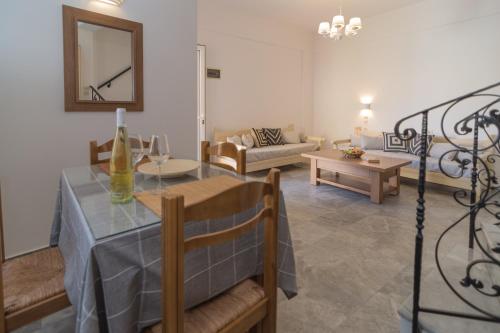 a living room with a table and a couch at Harbour Studios And Apartments in Palaiochóra