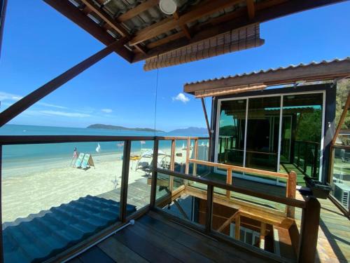 a view of the beach from the balcony of a beach house at Cenanghill Beachfront in Pantai Cenang