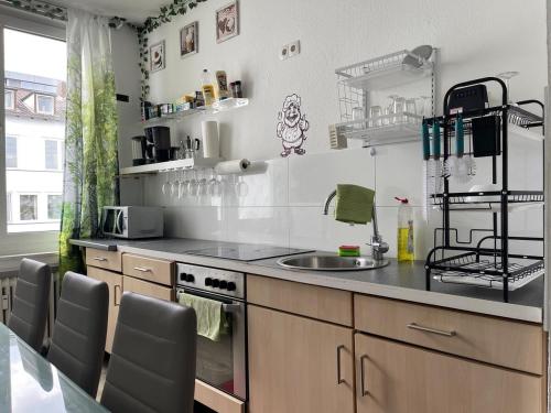 a kitchen with a counter and a sink and a stove at Cozy room 500 m to uni-Kassel in Kassel