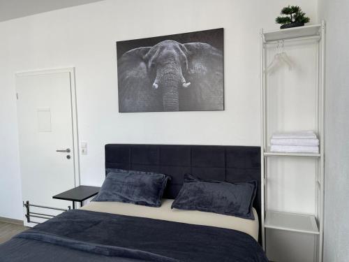 a bedroom with an elephant picture on the wall at Cozy room 500 m to uni-Kassel in Kassel