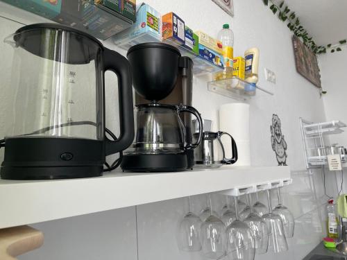 a coffee maker on a shelf in a kitchen at Friendly-room 200 m to 5 museums in Kassel