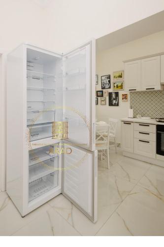 a white refrigerator with its door open in a kitchen at Fabulous Bulevard Ultracentral Apartament in Arad