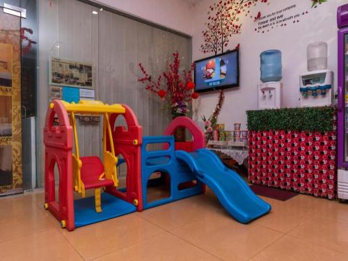 a play room with a playground with a slide at Super OYO 1114 Neo Pegasus Hotel in Segamat