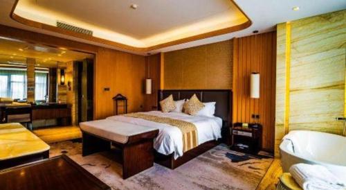 a bedroom with a large bed and a bath room at Suzhou Qingshan Conference Center in Suzhou