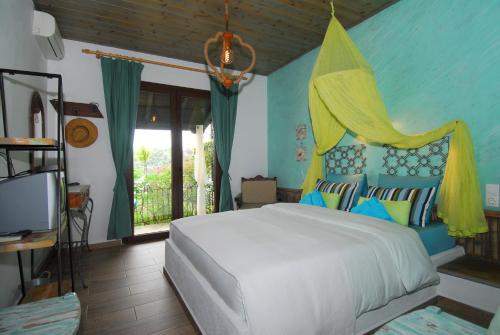 a bedroom with a white bed and blue walls at Dimitra Apartments in Milína