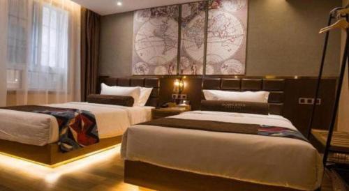 a bedroom with two beds and a map on the wall at James Joyce Coffetel·Kaifeng Drum Tower in Kaifeng