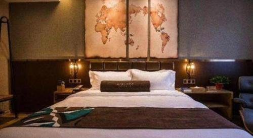 a bedroom with a large bed with a map on the wall at James Joyce Coffetel·Kaifeng Drum Tower in Kaifeng