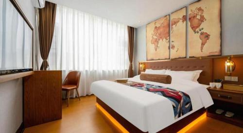 a bedroom with a large white bed with a map on the wall at James Joyce Coffetel·Lijiang Old Town Centeral in Lijiang