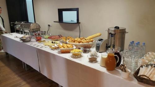 a table with a buffet of food on it at Hotel Doesi in Tbilisi City