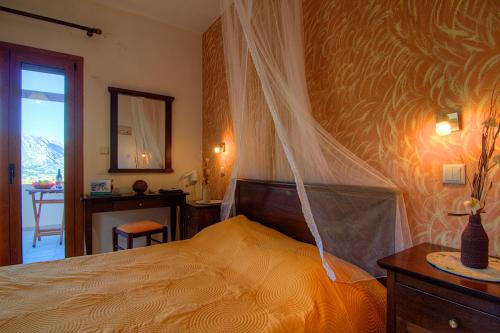 a bedroom with a bed with a mosquito net at Elia Meronas in Méronas