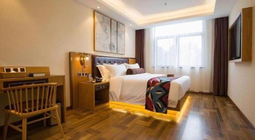 a hotel room with a bed and a window at James Joyce Coffetel· Hefei Anhui Agricultural University in Hefei