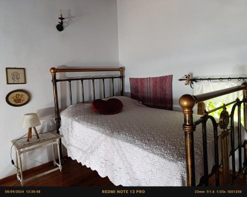 a bedroom with a bed with a hat on it at Panoramma Hause, Kampos Evdilou,Ikaria in Évdhilos