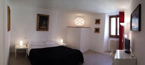 a bedroom with a bed and two tables and a window at Rinathos Guesthouse in Arezzo