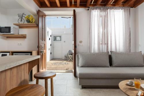 a living room with a couch and a table at Lindos Citrin Studios in Líndos