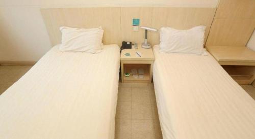 a room with two beds and a desk with a lamp at JinJiang Inn Nanjing The Confucius Temple Zhonghuamen Metro Station in Nanjing