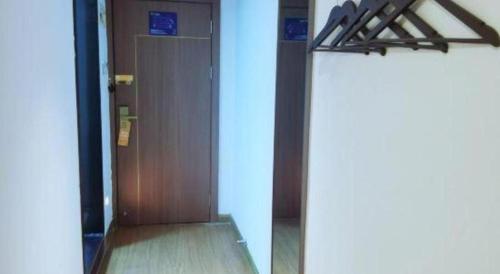 an open door in a room with a mirror at 7 Days Inn Guilin Beiji Plaza Yushan Garden in Guilin