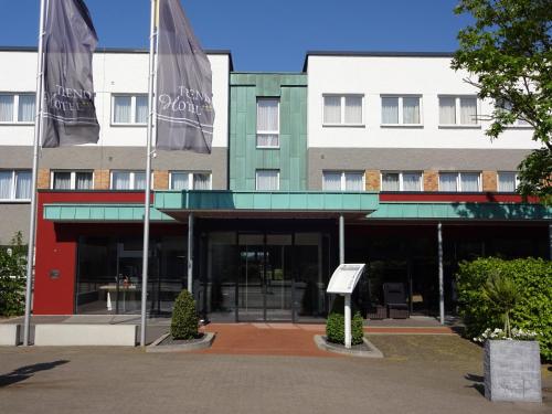 a building with two flags in front of it at Trend Hotel in Banzkow