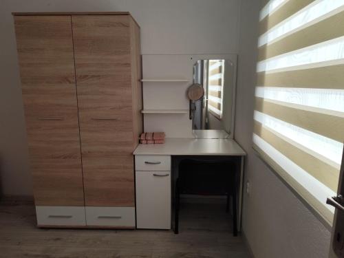 a small kitchen with a desk and a window at Ris kuca za odmor in Foča