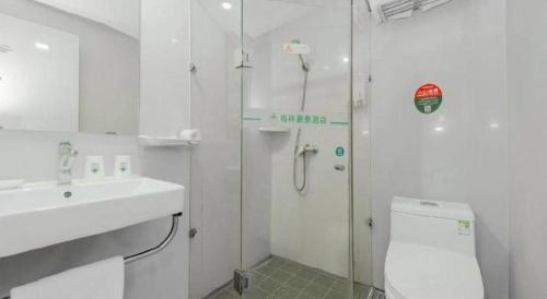 a bathroom with a shower and a sink and a toilet at GreenTree Inn Nanjing Confucius Temple Sanshan Street Subway Station Express Hotel in Nanjing