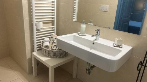 a bathroom with a sink and a mirror at Villa del glicine in Muro Leccese