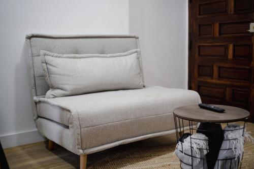 a living room with a couch and a table at Apartamento JADA in Albufeira